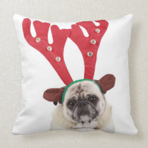 Embarrassed looking Pug wearing Reindeer Antlers Cushion
