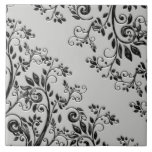 Embossed Black Swirly Floral Ceramic Tile<br><div class="desc">Ornate and elegant design features richly textured black leaves and curled vines given a dimensional embossed effect digitally on a silver background.</div>