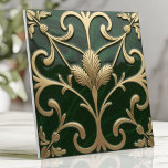 Emerald and Gold Art Nouveau Floral Ceramic Tile<br><div class="desc">Bring elegance and sophistication to your space with this deep emerald and gold Art Nouveau-inspired design. Featuring flowing organic floral and vine patterns, intricate metallic accents, and stylised botanical curves, this piece exudes vintage charm. The slightly raised embossed elements and swirling details create a timeless and luxurious aesthetic, perfect for...</div>