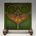 Emerald Grace Art Nouveau Ceramic Tile<br><div class="desc">Infuse your home with the timeless elegance of the "Emerald Grace Art Nouveau Ceramic Tile, " a stunning piece that embodies the fluidity and organic beauty of the Art Nouveau movement. This ceramic tile, printed by Zazzle, features a captivating design with flowing lines and a central motif in rich shades...</div>