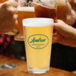 Emerald Green Stylised Wedding Groomsman Name Glass<br><div class="desc">Beer glass for the wedding groomsman that features his name printed in an emerald green colour, stylised script inside an emerald green, oval border along with wedding date. A great party supply idea for a bachelor party! Personalise your beer glass by editing and replacing name and date with your own....</div>