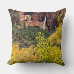 Ephemeral waterfall pours out of slot in cliff cushion