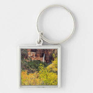 Ephemeral waterfall pours out of slot in cliff key ring