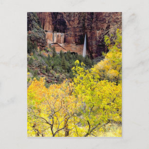 Ephemeral waterfall pours out of slot in cliff postcard