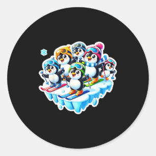 Excited penguins skiing together in snow adventure classic round sticker