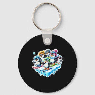 Excited penguins skiing together in snow adventure key ring