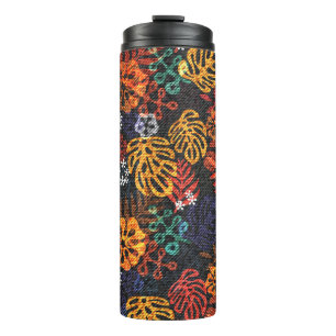 Exotic leaves on denim, seamless print. thermal tumbler