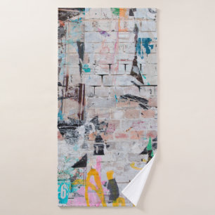 Exposed weathered brick wall with torn street post bath towel