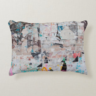 Exposed weathered brick wall with torn street post decorative cushion