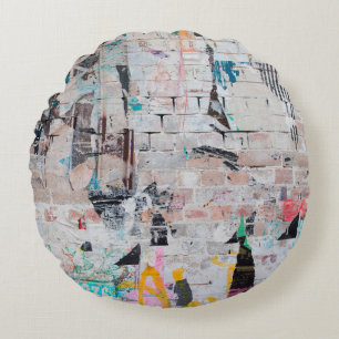 Exposed weathered brick wall with torn street post round cushion
