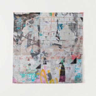 Exposed weathered brick wall with torn street post tapestry