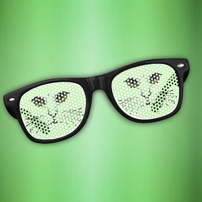 Face of Cat in black Green eyes Whiskers on Green Retro Sunglasses (Cute cat face with dark green eyes long whiskers on light green background on retro party glasses.)