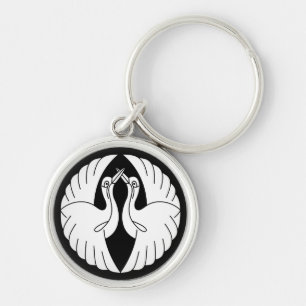 Facing white cranes key ring