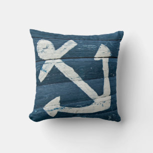 faded nautical anchor on rustic blue cushion