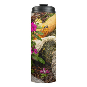 Fall gourds and impatiens flowers in garden thermal tumbler