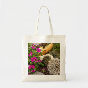 Fall gourds and impatiens flowers in garden. tote bag