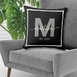 Family Name Black Newlywed Monogram Cushion<br><div class="desc">Personalised Newlywed Monogram Throw Pillow with Year Established. This chic pillow makes the perfect gift for newlyweds, celebrating their new life together with style and personalisation. Featuring a bold grey initial over a sleek black background, the couple’s last name is displayed in elegant white script calligraphy, with their "established" year...</div>