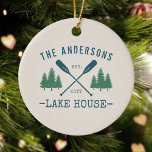 Family Name Lake House Rustic Oars Pine Trees Ceramic Ornament<br><div class="desc">A beautiful, rustic themed ceramic ornament, featuring your family name and lake house, cabin, cottage or other desired text and its established date, all in rustic style typography. This unique, custom design features teal blue boat oars, paddles and pine trees in soft green. The designs cream base colour is easily...</div>