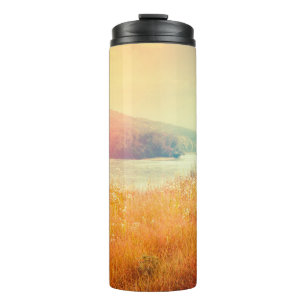 Fantastic foggy river with fresh grass in the sunl thermal tumbler