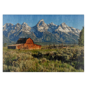 Farms Barn Shadowed by Snow Capped Mountains Cutting Board