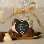 Faux Gold Chevron We're Engaged Engagement Classic Round Sticker<br><div class="desc">This round sticker features an elegant geometric chevron and the word "We're Engaged" in faux gold against a black background. It's great for an engagement celebration. Check out matching invitations and items here http://www.zazzle.com/collections/modern_faux_gold_chevron_celebration_collection-119531050277382712?rf=238364477188679314 Personalise it with your details by replacing the placeholder text. For more options click the "Customise it"...</div>