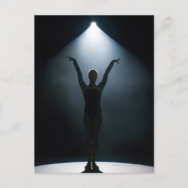 Female gymnast performing in spotlight, studio postcard (Front)