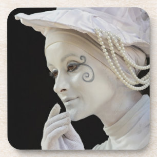 Female mime performing on street corner coaster