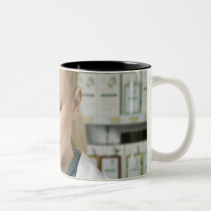 Female pharmacist looking at medicine in Two-Tone coffee mug