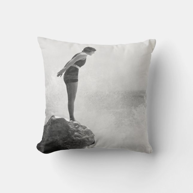 Female swimmer on rock above crashing surfvintage, cushion (Front)