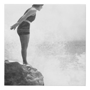 Female swimmer on rock above crashing surfvintage, faux canvas print