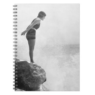 Female swimmer on rock above crashing surfvintage, notebook