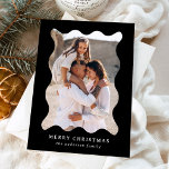 Festive Black Retro Photo Frame Merry Christmas Holiday Card<br><div class="desc">Send festive holiday greetings to your friends and family with this trendy holiday photo card! The simple Christmas card displays your vertical photo framed in a wavy, black retro-style frame. Personalise the minimal holiday card with a custom greeting (shown as Merry Christmas) and your family name in white lettering. The...</div>