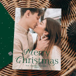 Festive Elegance Green Merry Christmas Photo Holiday Card<br><div class="desc">Simple holiday card featuring your full-bleed vertical photo with "Merry Christmas" displayed in elegant green lettering. Personalise the elegant photo Christmas card with your family name and the year. The card reverses to display a green background with subtle white dots.</div>