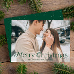 Festive Elegance Green Merry Christmas Photo Holiday Card<br><div class="desc">Simple holiday card featuring your full-bleed horizontal photo with "Merry Christmas" displayed in elegant green lettering. Personalise the elegant photo Christmas card with your family name and the year. The card reverses to display a green background with subtle white dots.</div>