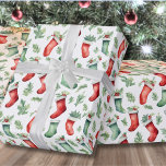 Festive Red Green Stockings Christmas Wrapping Paper<br><div class="desc">Add a touch of festive elegance to your holiday gifts with this wrapping paper featuring a Christmas stocking and holly leaf pattern in green and red against a white background. You can customise the background to any colour to match your holiday theme. This design brings joy to your Christmas presents...</div>