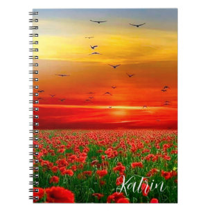 field of poppies against the backdrop of a red sun notebook
