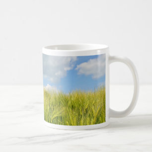 field with young wheat in bright summer day coffee mug