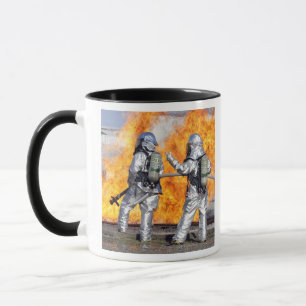 Firefighters battle a simulated fire mug