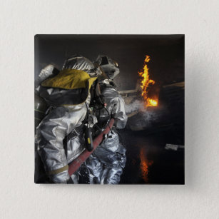 Firefighters extinguish a fire in a training ro 15 cm square badge