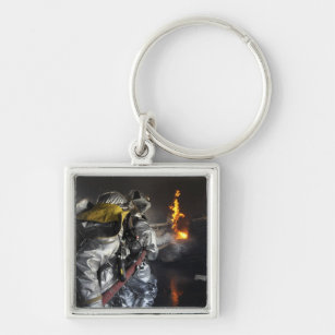 Firefighters extinguish a fire in a training ro key ring
