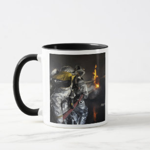 Firefighters extinguish a fire in a training ro mug