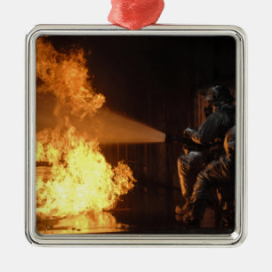 Firefighters extinguish a simulated battery fir metal ornament