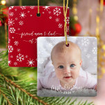 First Christmas Baby Photo New Parents Snowflakes Ceramic Ornament<br><div class="desc">“First Christmas.” A playful visual of white snowflakes and handwritten script typography with customised year, overlaying the photo of your choice, help you usher in Christmas and New Year. On the back, additional white snowflakes and handwritten typography with “proud mum & dad of baby’s name” overlay a red background. Feel...</div>