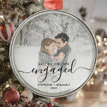 First Christmas Engaged Custom Photo Black Script Metal Ornament<br><div class="desc">Commemorate your engagement with this beautiful modern keepsake ornament. The black text reads "Our first Christmas engaged, " with the word "engaged" in elegant handwriting script with flourishes before and after. Replace the sample image with your favourite photo, and add your names and the year. A white gradient filter helps...</div>