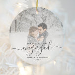 First Christmas Engaged Custom Photo Gray Script Ceramic Ornament<br><div class="desc">Commemorate your engagement with this beautiful modern keepsake ornament. The charcoal gray text reads "Our first Christmas engaged, " with the word "engaged" in elegant handwriting script with flourishes before and after. Replace the sample image with your favorite photo, and add your names and the year. A white gradient filter...</div>