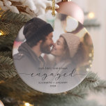 First Christmas Engaged Custom Photo Grey Script Ceramic Ornament<br><div class="desc">Commemorate your engagement with this beautiful modern keepsake ornament. The charcoal grey text reads "Our first Christmas engaged, " with the word "engaged" in elegant script with swashes before and after. Replace the sample image with your favourite photo, and add your names and the year. A white gradient filter helps...</div>