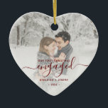 First Christmas Engaged Custom Photo Red Script Ceramic Ornament<br><div class="desc">Commemorate your engagement with this beautiful modern keepsake ornament. The dark red text reads "Our first Christmas engaged, " with the word "engaged" in elegant handwriting script with flourishes before and after. Replace the sample image with your favourite photo, and add your names and the year. A white gradient filter...</div>