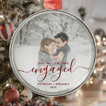 First Christmas Engaged Custom Photo Red Script Metal Ornament<br><div class="desc">Commemorate your engagement with this beautiful modern keepsake ornament. The dark red text reads "Our first Christmas engaged, " with the word "engaged" in elegant handwriting script with flourishes before and after. Replace the sample image with your favourite photo, and add your names and the year. A white gradient filter...</div>