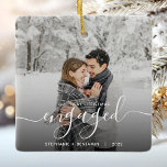 First Christmas Engaged Custom Photo White Script Ceramic Ornament<br><div class="desc">Commemorate your engagement with this beautiful modern keepsake ornament. The white text reads "Our first Christmas engaged, " with the word "engaged" in elegant handwriting script with flourishes before and after. Replace the sample image with your favorite photo, and add your names and the year. A black gradient filter helps...</div>