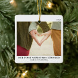 First Christmas Engaged Minimal Engagement Photo Ceramic Ornament<br><div class="desc">Celebrate your first Christmas as an engaged couple with our First Christmas Engaged Minimal Engagement Photo Ceramic Ornament. This elegant ornament combines a clean, minimalist design with classic black and white, perfect for those who appreciate simplicity and sophistication. The custom ceramic ornament features a space for your favourite engagement photo,...</div>